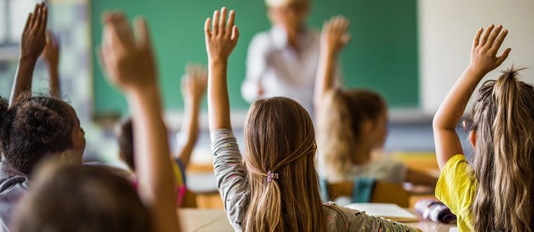 students raising hands
